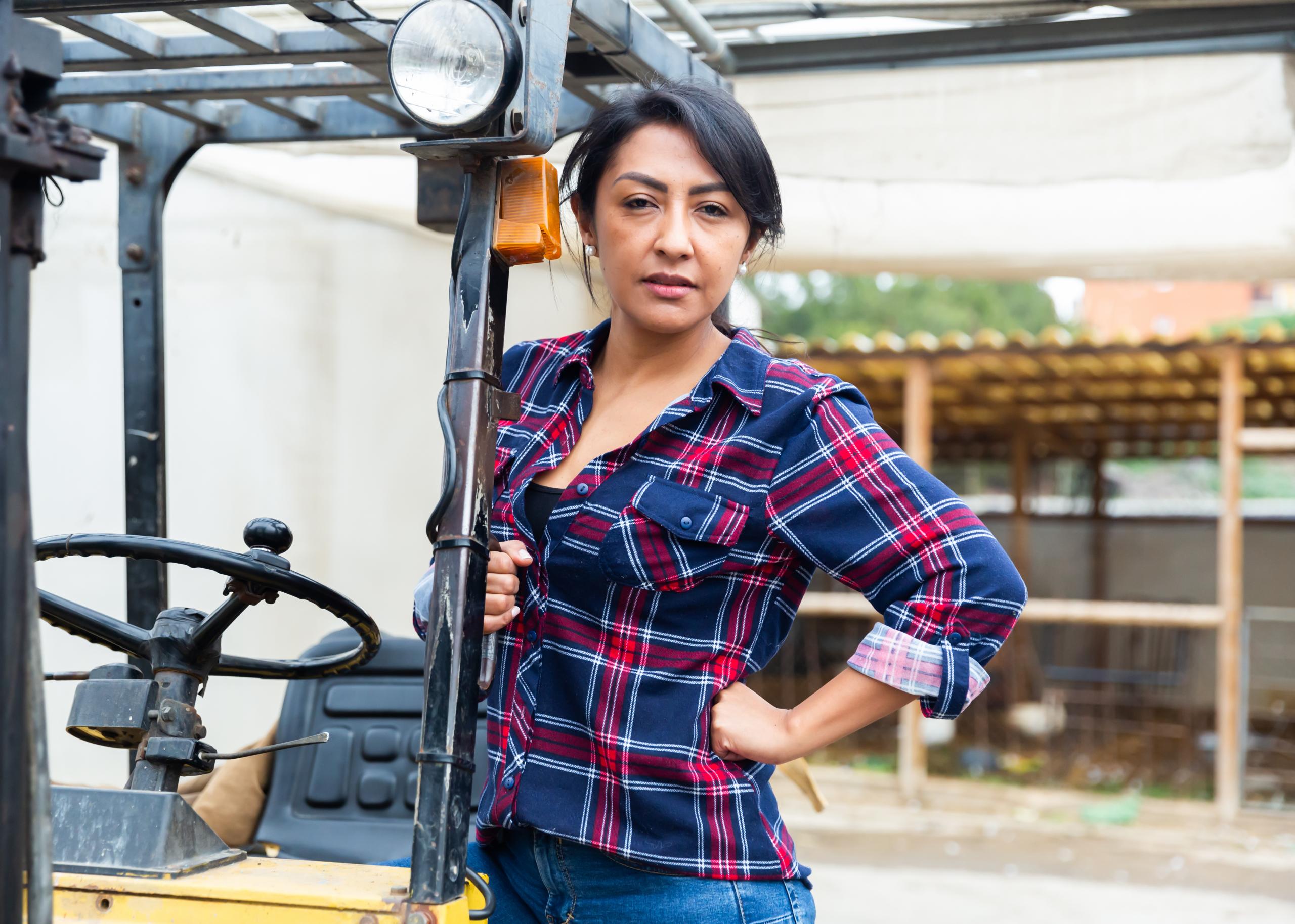 Hispanic Woman Behind The Wheel Of Forkliftjpeg